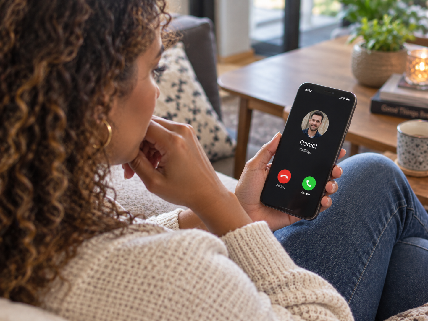 Mixed-race woman looking at an incoming call on her phone after someone has gone quiet